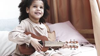 BabyBj rn - a young girl playing with a ukelele | Trending HD Video