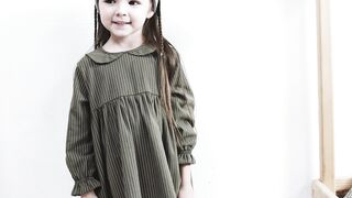 BabyBj rn - a girl standing in the playroom happily showing her dress | Trending HD Video