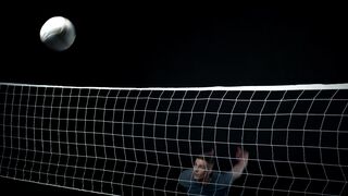 Action figure - volleyball sportsman demonstrating jump serve from behind net | Trending HD Vid