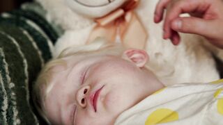 BabyBj rn - a person touching the hair of the sleeping baby | Trending HD Video