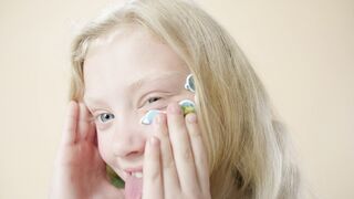 Funnyfuzzy - a girl with her eyes closed and her hands on her face | Trending HD Video