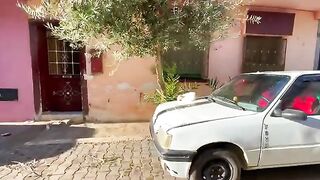 This cat sleeping on top of the car is surprised by gentle touches and a plate of delicious food.