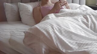 Wonder Woman - a woman using her smartphone while lying in bed | Trending HD Video