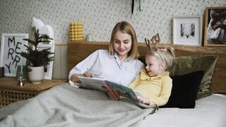 BaByliss - a mother reading a story book to her daughter | Trending HD Video