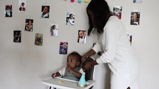 Wonder Woman - woman fixing the bib of the baby | Trending HD Video