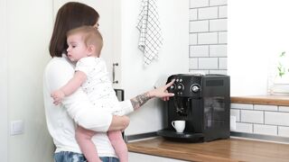 The Shy Snow Woman and the Cursed Ring - woman prepares coffee while holding her baby | Trendin