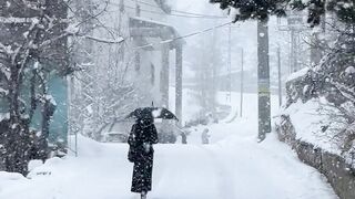 Winter Coat - snowy winter street with walking figure | Trending HD Video