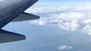Travelpro - airplane wing view over scenic clouds | Trending HD Video
