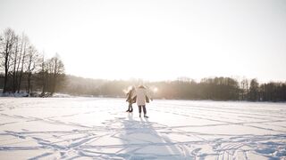 Winter Coat - a couple skating in frozen lake in the middle of the forest | Trending HD Video