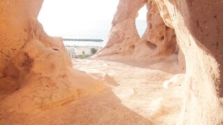 Travel Backpack - the sun is shining through the rocks at the top of a cliff | Trending HD Vide