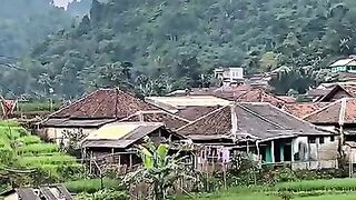 Village under the mountain slope