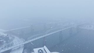 Winterhalter - aerial winter view of foggy bridge crossing river | Trending HD Video