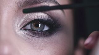 The Shy Snow Woman and the Cursed Ring - a woman applying mascara to thickens and enhanced her