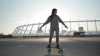Woman Within - skateboarding in front of modern stadium | Trending HD Video