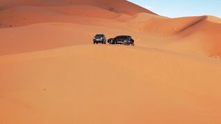 Travelon - aerial view of desert dunes with suvs | Trending HD Video