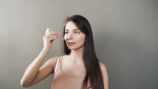 Woman Within - woman using a jade roller | Trending HD Video