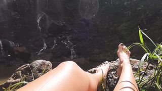 Wonder Woman - a woman s legs are in the grass with a waterfall in the background | Trending HD