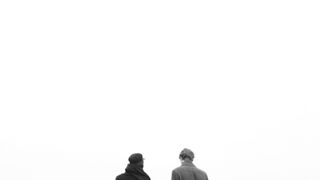 Winter Coat - a couple walking hand in hand along the sidewalk by the riverbank | Trending HD V