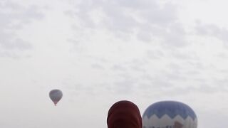 Woman Within - woman in white dress against hot air balloons | Trending HD Video