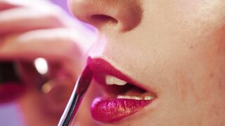 Woman Within - person applying lipstick on a woman | Trending HD Video