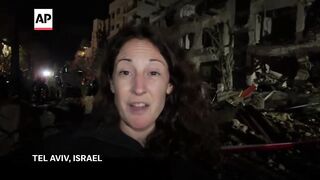 Israeli authorities respond after Iranian missile hits area of Tel Aviv.