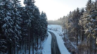 Winterhalter - snowy forest road drone view in winter landscape | Trending HD Video