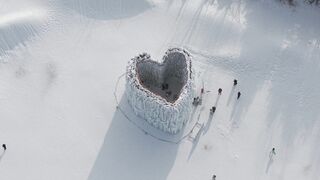 Snow boot - aerial view of heart shaped ice structure in snow | Trending HD Video