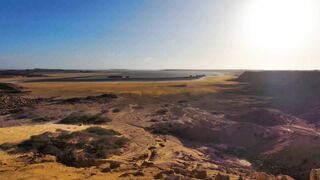 travelite - drone footage of a desert by the sea on a sunny day | Trending HD Video