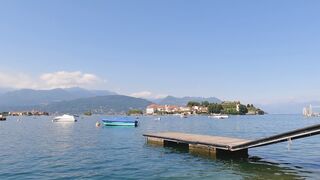 Travelpro - a floating wooden dock and anchored boats on lago maggiore italy | Trending HD Vide