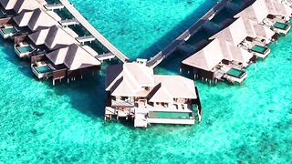 travelite - aerial view of luxury overwater bungalows | Trending HD Video