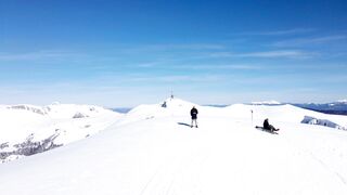 Snow boot - a man flying a drone in a snow covered mountain landscape | Trending HD Video