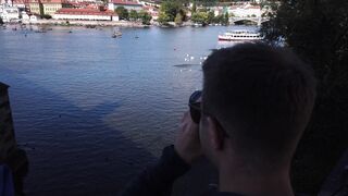 Travelpro - tourists watching the river event in czech republic | Trending HD Video 2