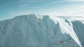 Travelon - aerial view of snow covered mountain summit | Trending HD Video