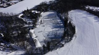 Winter Coat - aerial footage of a building in snowy field | Trending HD Video