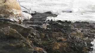 Winter solstice - a river with flowing water under an ice | Trending HD Video