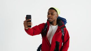 Travel Backpack - a hiker man recording a video using smartphone | Trending HD Video