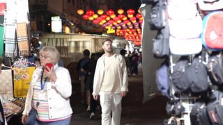 Travelpro - bustling night market with lanterns and shoppers | Trending HD Video