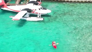 Travelpro - aerial view of seaplane docked in tropical paradise | Trending HD Video