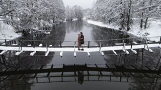 Winter solstice - drone shot of couple on bridge in winter | Trending HD Video