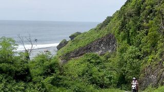Travelon - a person walking down a road near the ocean | Trending HD Video