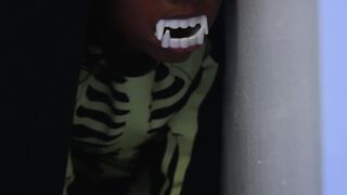 Funny Gift Ideas - a little black girl wearing a fake vampire teeth and skeleton costume | Tren