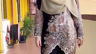 Elegant Woman in Traditional Attire Walks Down a Vibrant Hallway