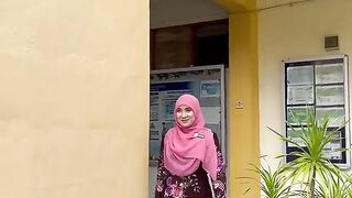 Woman in Pink Hijab Walks Out of Building