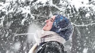 Winter solstice - woman enjoying snowfall in winter forest | Trending HD Video