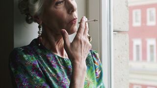 Woman Within - woman smoking while observes trough glassdoor | Trending HD Video