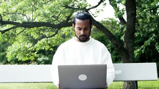 Notes on Being a Man - a man working with a laptop outdoors | Trending HD Video