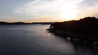 travelite - the sun sets over the water and land in this photo | Trending HD Video