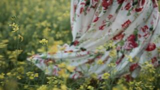 The Pioneer Woman - a woman walking on a field of flowers while wearing a floral dress | Trendi