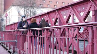 Funnyfuzzy - people walking on red steel bridge in wroclaw | Trending HD Video