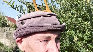 Notes on Being a Man - man with chicken on hat enjoying outdoors | Trending HD Video